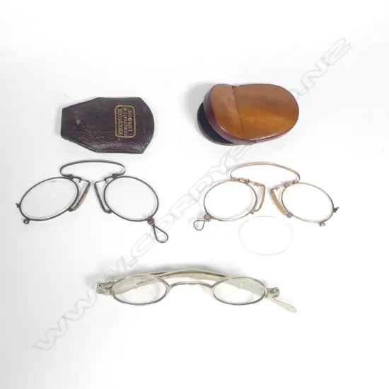 Two pair of folding C-spring pince nez, one gold plated in French wooden compact case, the other steel in optician named leather case, along with a pair of 'Pickwick' spectacles with telescoping arms
