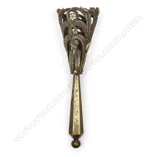A gilt brass bouquet holder, possibly French, the cone cast and pierced with acanthus and lilies, on a hexagonal tapering handle. H.155mm