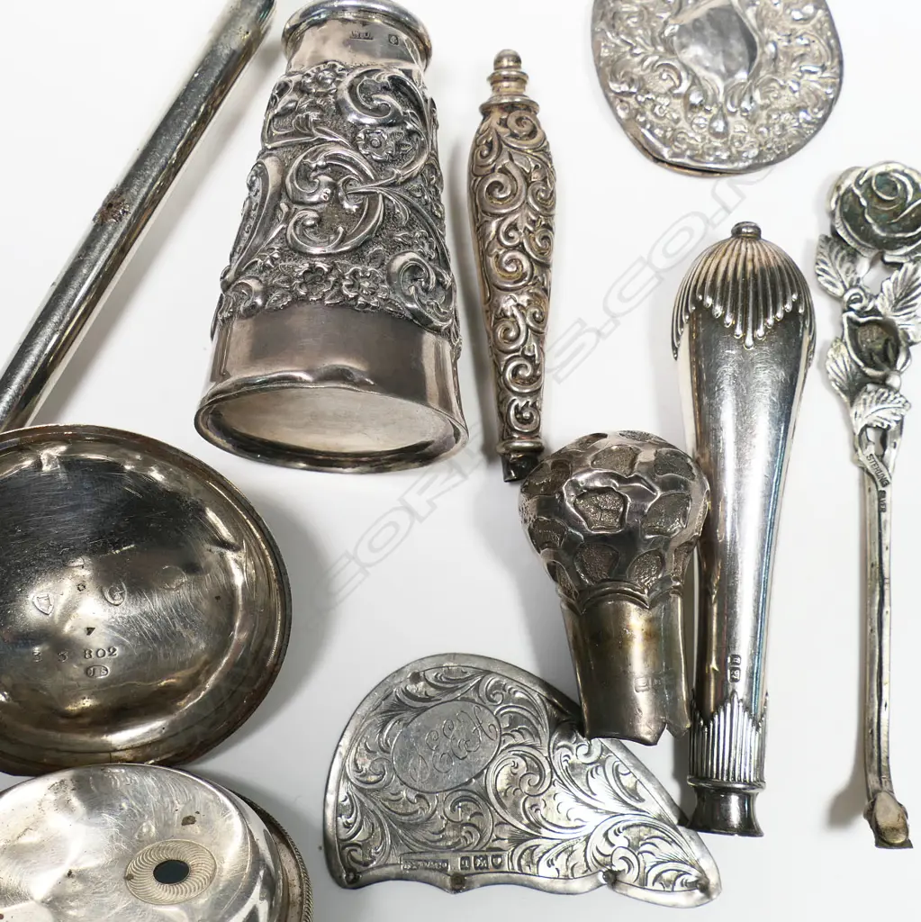 A large sterling silver Reynolds Angels button hook, Birmingham 1906 (dents) along with a silver walking cane top and other scrap silver. Image 1++