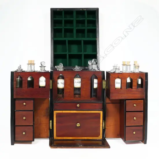 A George III period mahogany apothecary box, of tall oblong form with satinwood clashing and corners to the hinged lid, fitted with a stirrup handle. The front opening wing doors revealing an interior of 18 compartments and glass bottles, the front partitions pierced with Gothic openings to reveal the bottle labels,