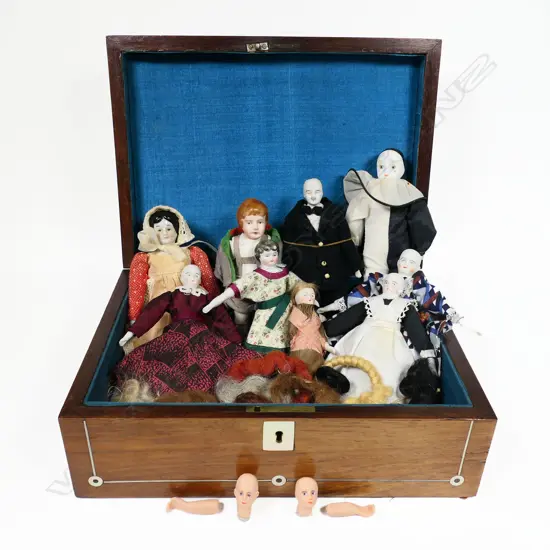 A late 19thC walnut workbox, inlaid with mother-of-pearl escutcheon, cartouche and rondels. Blue silk interior. With a collection of various doll's house dolls and parts. 280 x 200 x 100mm.