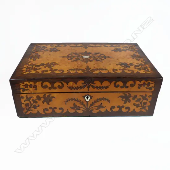A Victorian birds eye maple and rosewood marquetry veneered workbox, with a symmetrical floral silhouette pattern. With key. 350 x 235 x 120mm