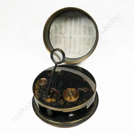 A blackened brass drum or pocket sextant by F Barker & Son, London, with silver scale from -5º to 140º, vernier from 0º to 30º, hinged and swivelling scale magnifier. Dia.80mm.