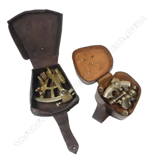 Two 20thC replica brass miniature sextants, both marked Stanley, 4" arc with military arrow and date 1916, the smaller 2½" arc dated 1884. With leather cases.