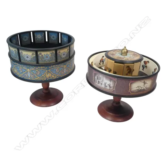 Two contemporary animation viewers by Hemisferium, a zoetrope and a praxinoscope, with approximately 30 animation strips, each rotating ring on turned wooden column base. H.220mm