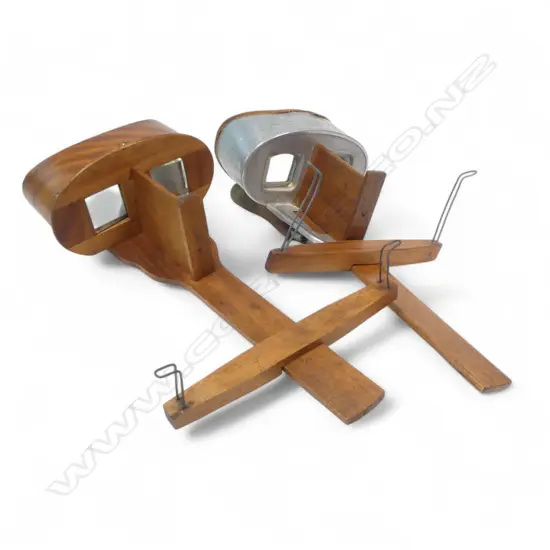 Two handheld stereoscopic viewers, one with zinc mounts marked Underwood & Underwood, New York.