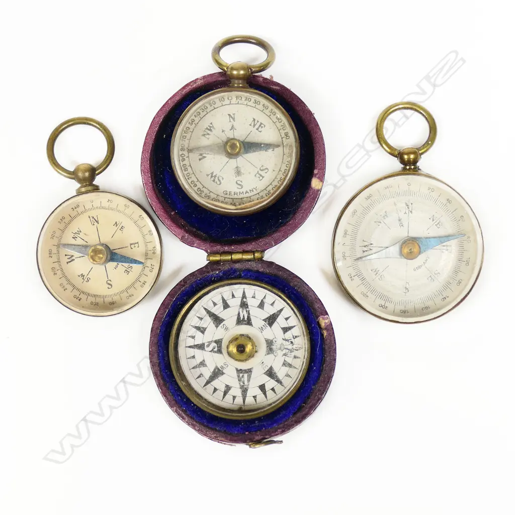 Four small pocket compasses; three open face with fob suspension and a floating dial in purple leatherette hinged case, Image 1++