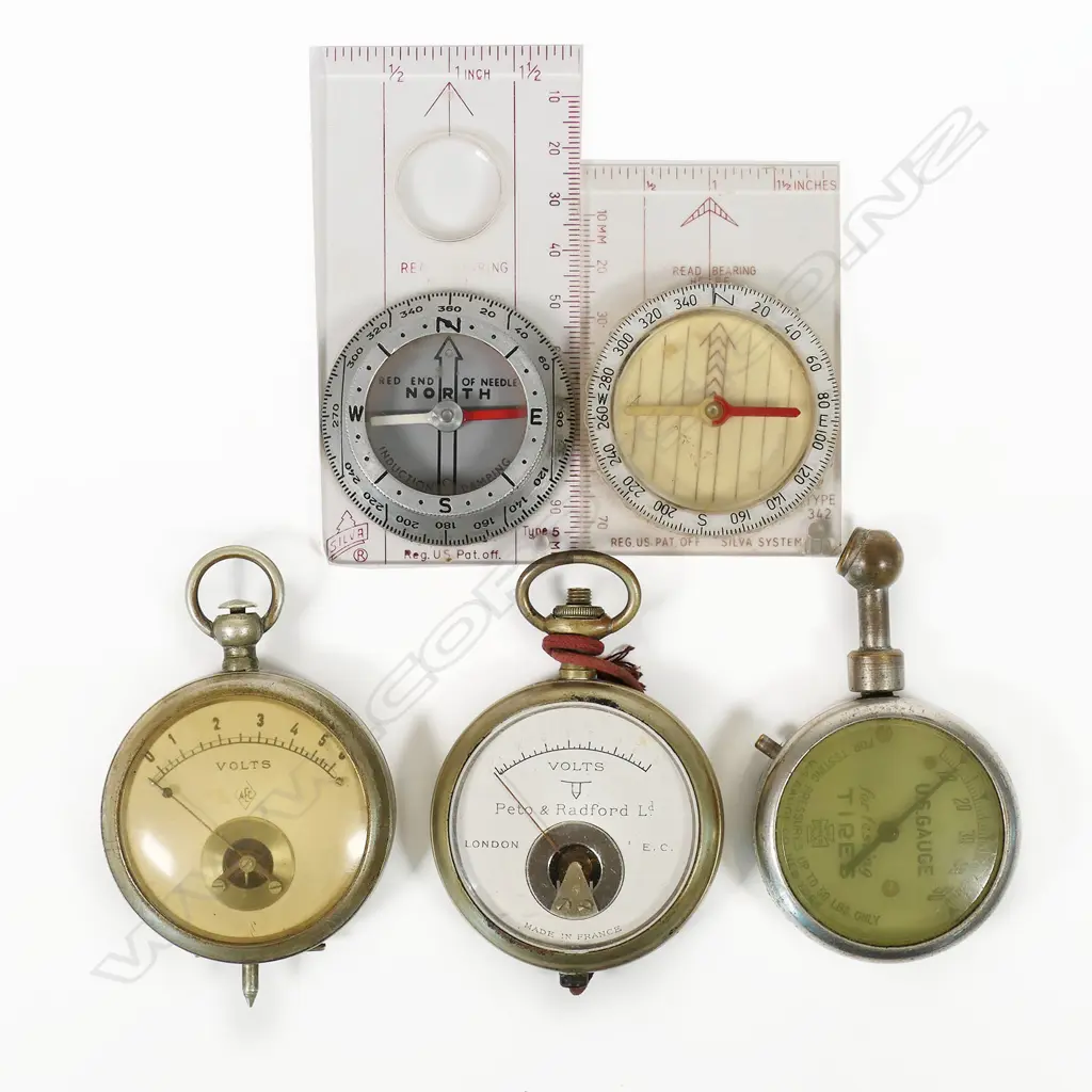 Two pocket watch-type voltmeters; US Gauge Co., NY tire pressure gauge; Silva Type 5 induction damped compass c.1960; and a Silva Type 342 compass. (5) Image 1++