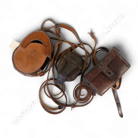 Three vintage leather instrument cases and three leather straps,