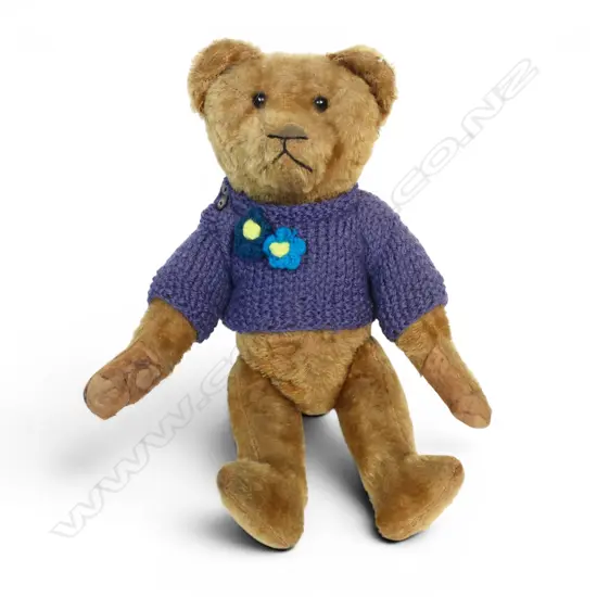 An early 20thC golden plush teddy bear,
