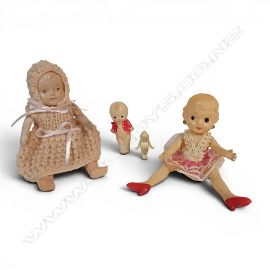 Three vintage small celluloid dolls and one mini carved bone,
