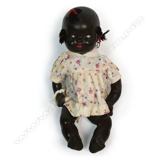 A black composition doll,