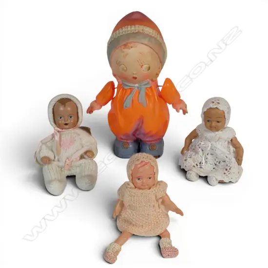 Four celluloid dolls - three miniature and one Boo Boo orange doll,