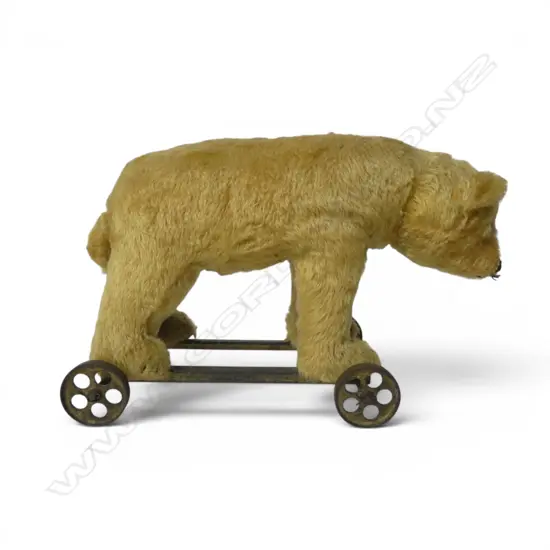 Vintage Steiff pull-along bear on metal frame with wheels,