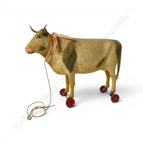 Antique European cow pull-toy on stand with wheels,