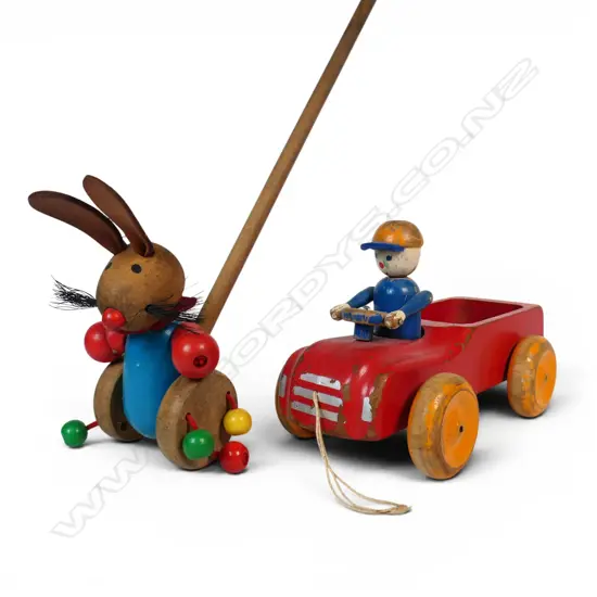 One vintage truck and driver pull-along toy and a bunny push-along toy,