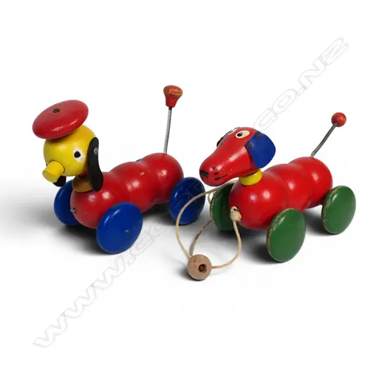 Two vintage wooden pull-along toy dogs,