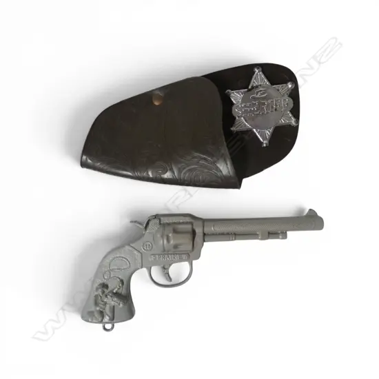 Vintage Prairie handgun with sheriff badge and holster,