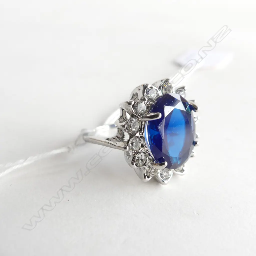 FAUX SAPPHIRE AND WHITE STONE RING IN SILVER PLATE Image 1++