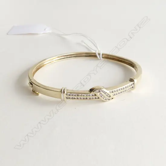 9CT GOLD AND DIAMOND SET BANGLE 0.68CT