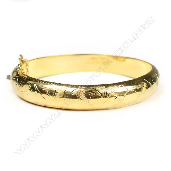 A sterling silver gold plated engraved hinge bangle,