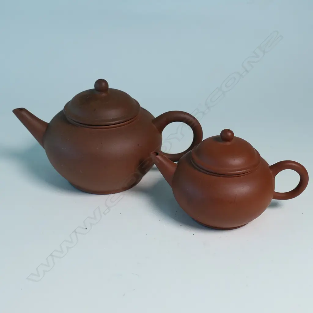 TWO SMALL YIXING TEAPOTS, MARKED 中國宜興. W.120 & 90mm Image 1++
