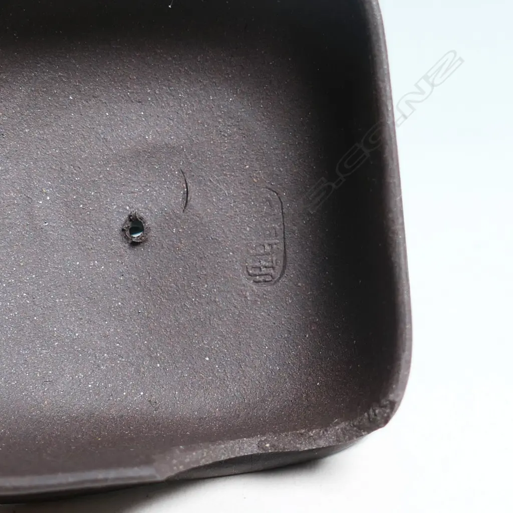 SMALL YIXING TEAPOT, SQUARE SECTION, BAMBOO HANDLE & SPOUT, INDISTINCTLY MARKED. COVER CHIPPED INSIDE. W.125mm... Image 1++