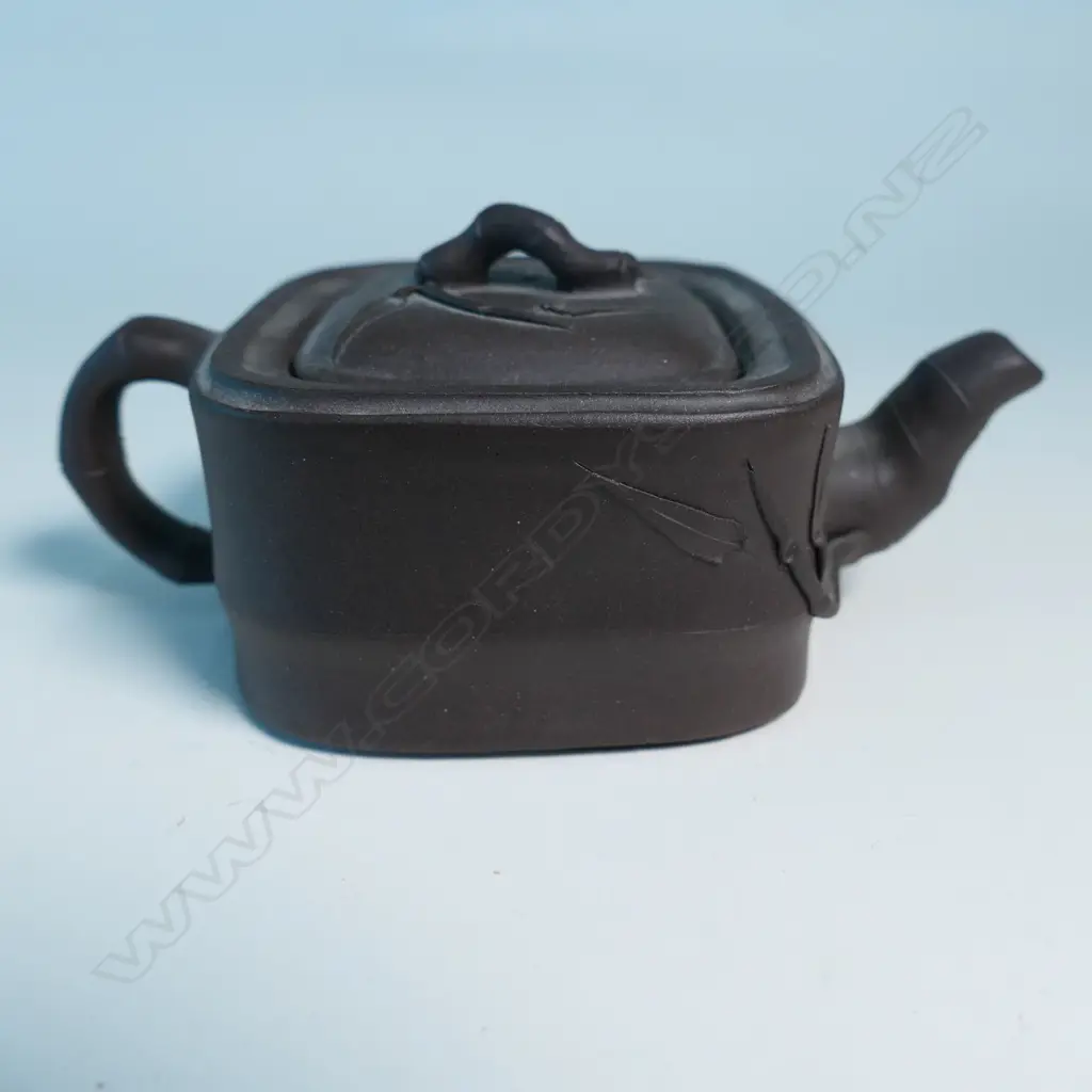 SMALL YIXING TEAPOT, SQUARE SECTION, BAMBOO HANDLE & SPOUT, INDISTINCTLY MARKED. COVER CHIPPED INSIDE. W.125mm... Image 1++