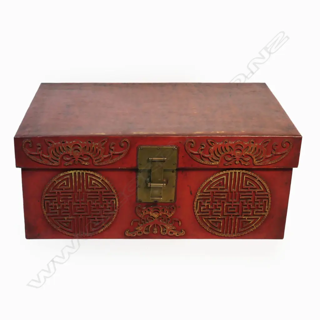 A vintage Chinese chest the exterior in rich sang de boeuf leather decorated with tooled gilt detailed sacred bats and peach kernel medallions brass lock and side handles. 780 x 340 x 1050mm. Image 1++