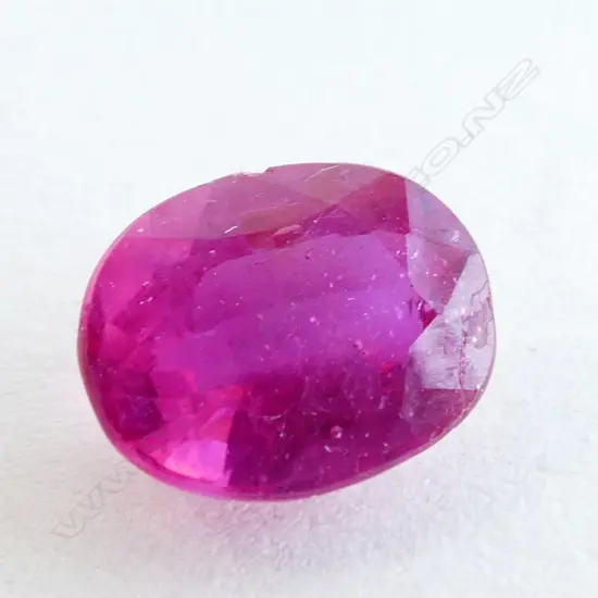 RED RUBY/GLASS FILLED GEMSTONE, OVAL FACET CUT, 3.10CTS WITH AIG REPORT