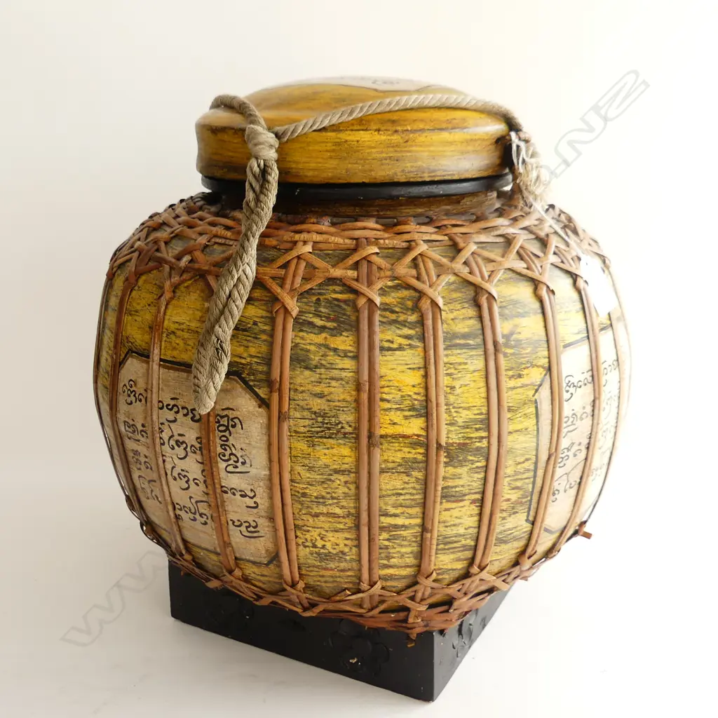 CANE COVERED LIDDED VESSEL. MADE IN THAILAND WITH THAI SCRIPT IN PANELS. LID ATTACHED BY ROPE. H.370 mm Image 1++