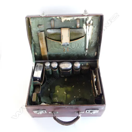 the dark green silk interior showing wear. With multiple original accessories - some monogrammed - in green leather
