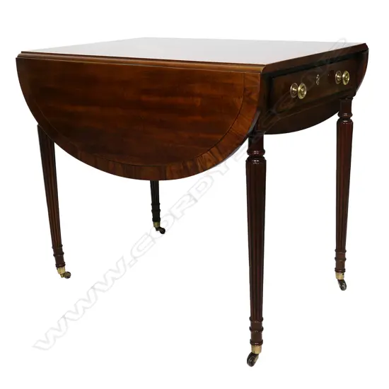 A Regency style Pembroke table inlay decoration drawer to one end raised on reeded tapering legs and brass casters. 760 x 500 x 690mm. (when closed).