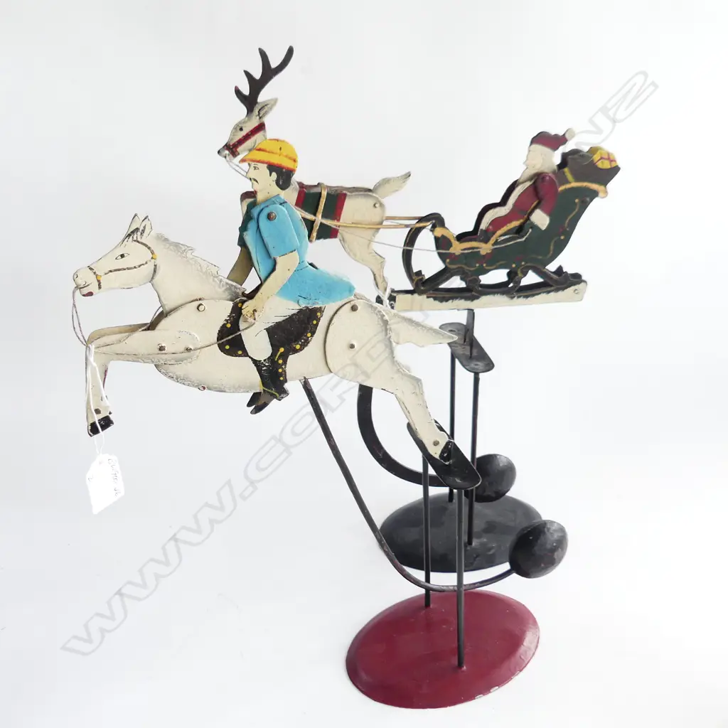 2 VINTAGE PAINTED METAL CONTER-BALANCED WEIGHT TOYS. SANTA IN SLEIGH & JOCKEY 0N HORSE H.450mm Image 1++