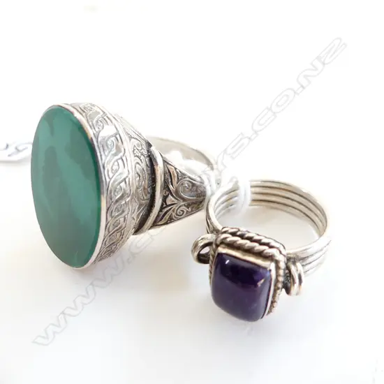 2 SILVER RINGS: 1 W LGE GREEN STONE the other w amethyst
