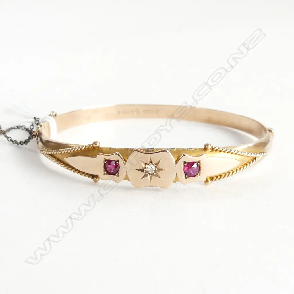 9CT GOLD BANGLE WITH 2 RUBIES AND CENTRAL DIAMOND. 8GMS faults Image 1++