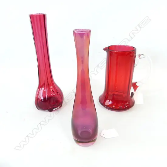 THREE RUBY GLASS ITEMS. TWO VASES H.205 & 225mm & A JUG (FAULTED ) H.150mm
