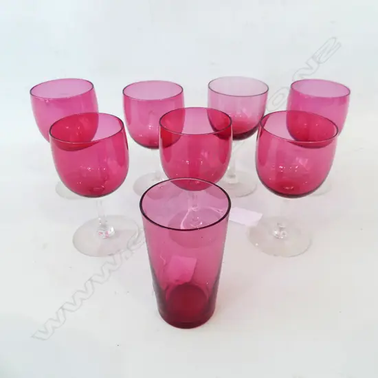 EIGHT RUBY GLASS GLASSES. SEVEN STEMMED AND ONE BEAKER.