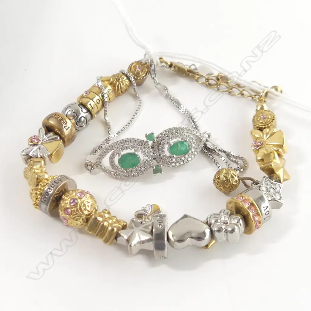 2 BRACELETS; 1 WITH EMERALDS & 1 WITH CHARMS Image 1++