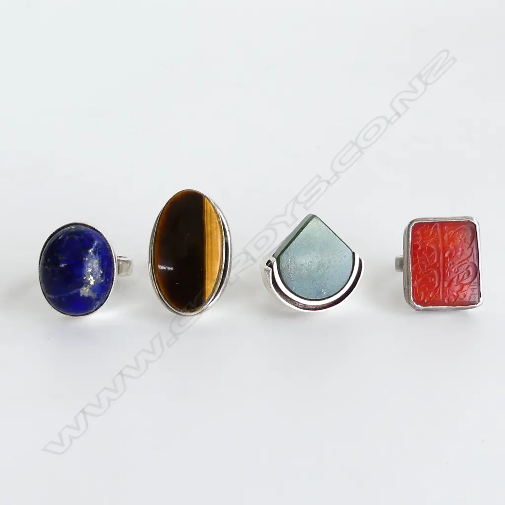 4 ASST. STG RINGS; LAPIS, CARNELIAN (both unmarked) TIGERS EYE, GREENSTONE 38 grams Image 1++