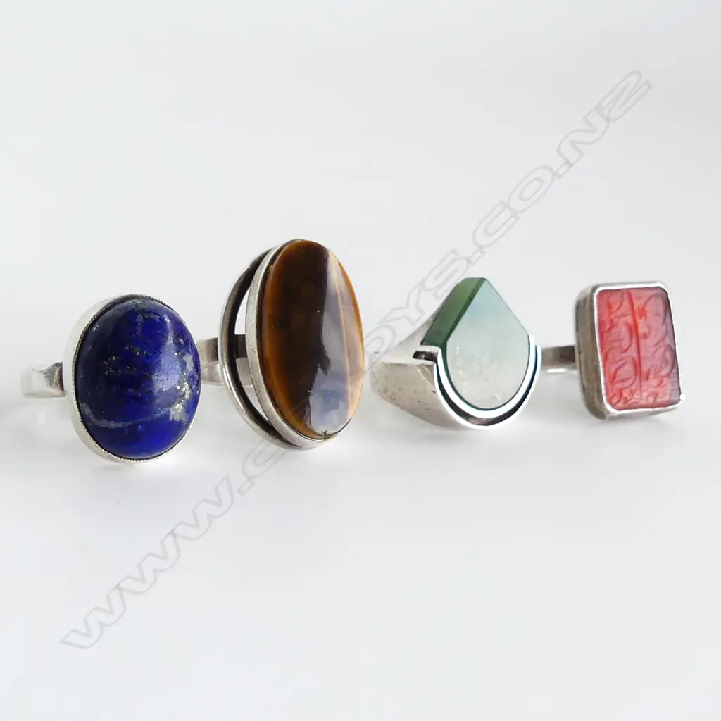 4 ASST. STG RINGS; LAPIS, CARNELIAN (both unmarked) TIGERS EYE, GREENSTONE 38 grams Image 1++