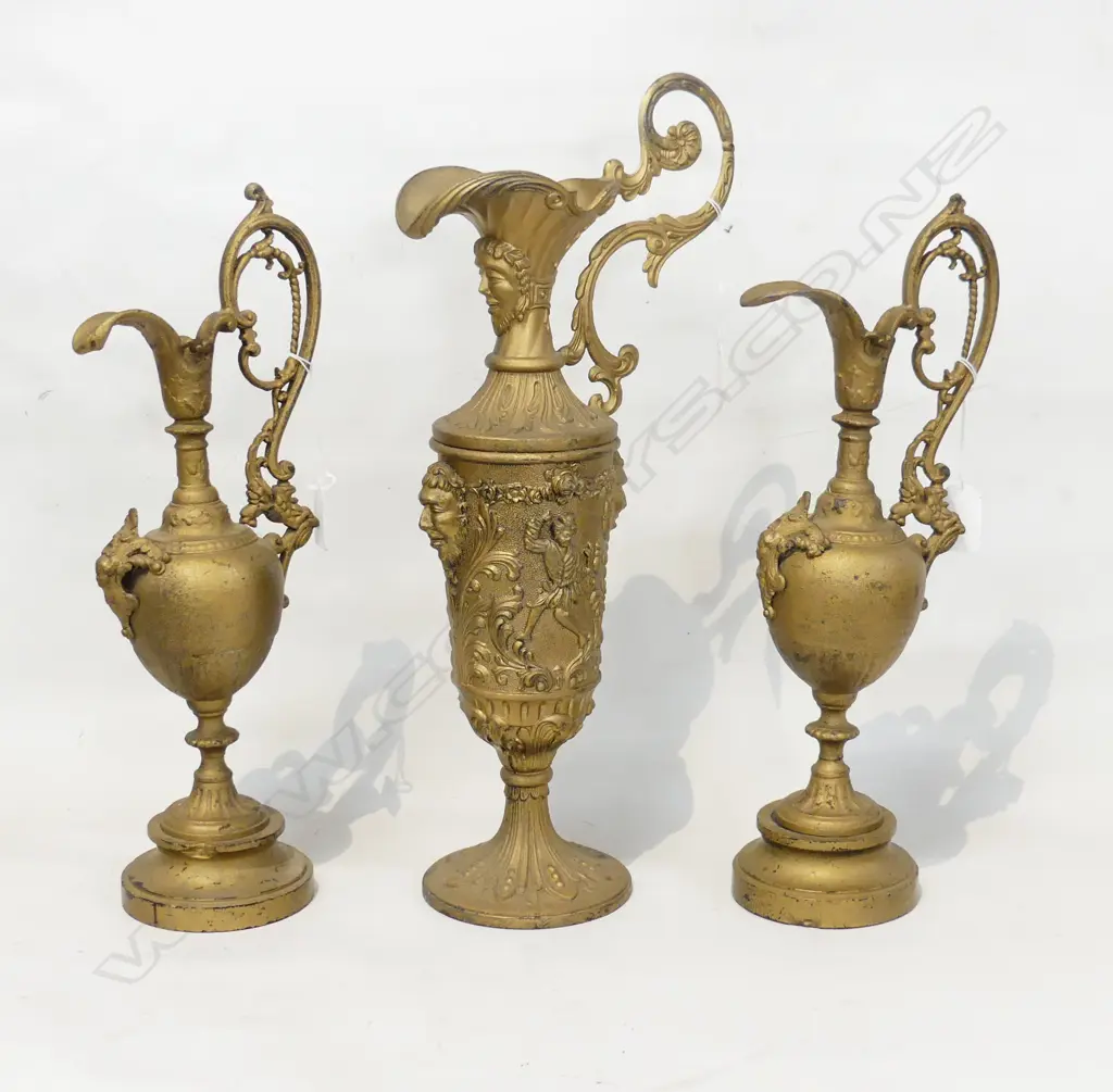 THREE GILDED SPE;TER EWERS. WITH SCROLL HANDLES LARGEST WITH MASK DETAIL. H. LGE 415 PAIR 365mm Image 1++