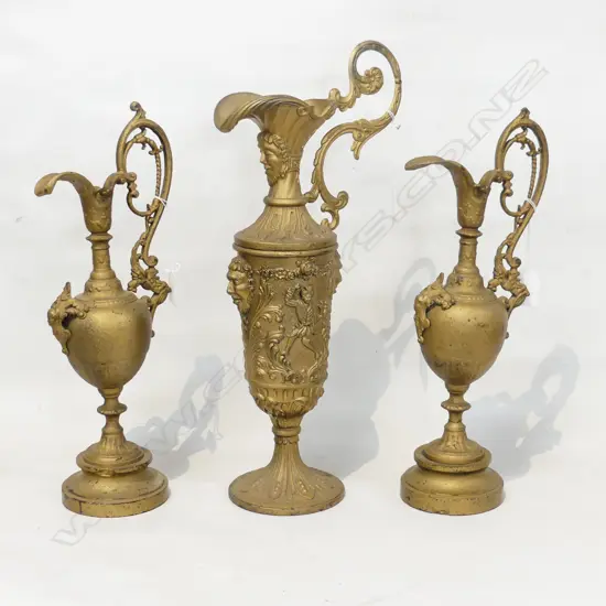 THREE GILDED SPE;TER EWERS. WITH SCROLL HANDLES LARGEST WITH MASK DETAIL. H. LGE 415 PAIR 365mm