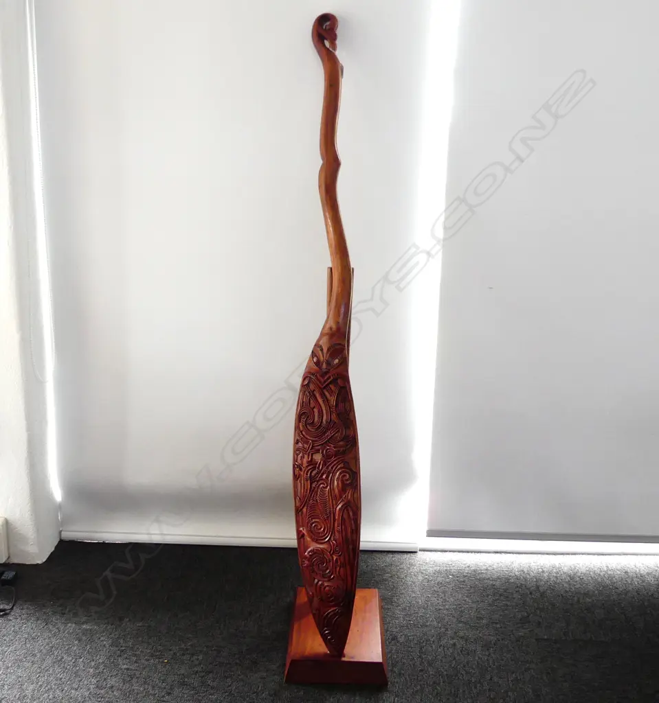 WAKA HOE; MAORI CARVED WOODEN ORNAMENTAL CANOE PADDLE L.1520mm ON STAND H.870mm Image 1++
