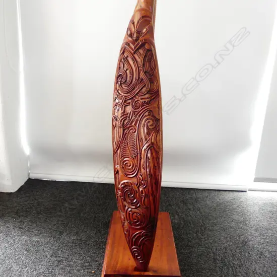 WAKA HOE; MAORI CARVED WOODEN ORNAMENTAL CANOE PADDLE L.1520mm ON STAND H.870mm