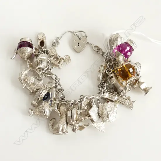SILVER CHARM BRACELET packed with dog.trophy.fish.longcase clockship etc 125gms