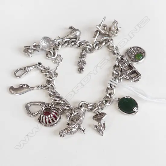 STG SILVER BRACELET w. ASST. NZ CHARMS 50.1 GRAMS