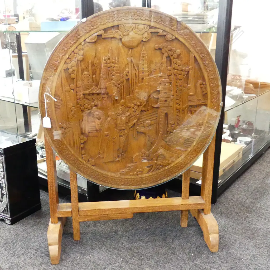 CIRCULAR FOLDING COFFEE TABLE WITH CARVED CHINESE SCENE UNDER GLASS. 605X520mm Image 1++