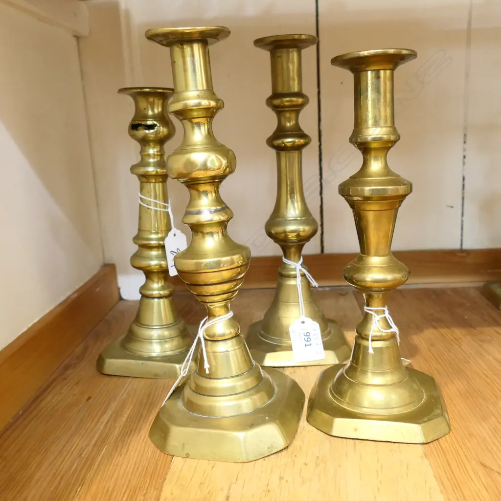 FOUR BRASS BALUSTER SHAPED OLD CANDLESTICKS. ALL APPROX 220mm HIGH. Image 1++
