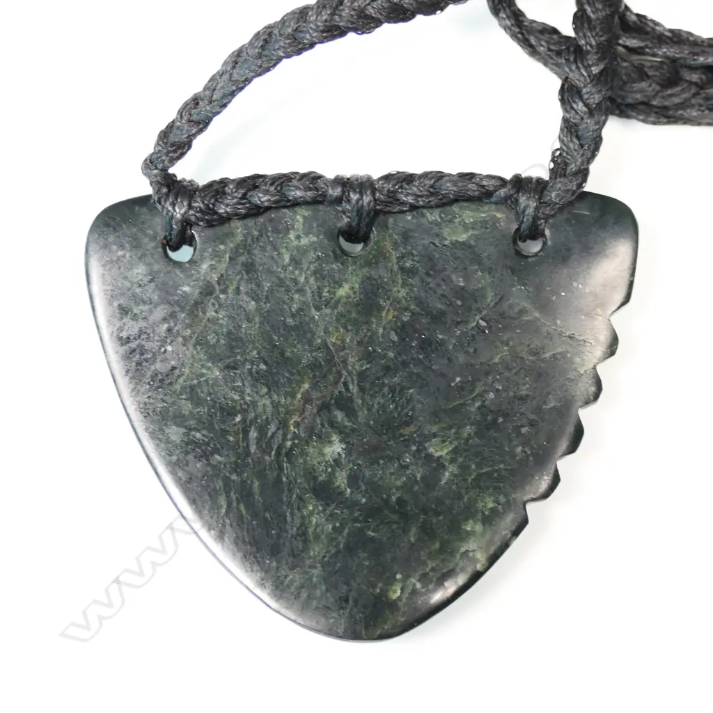 TE KAHA carved (dark arahura) pounamu lge notched triangular form pendant with certificate 2016. W.63mm. Image 1++
